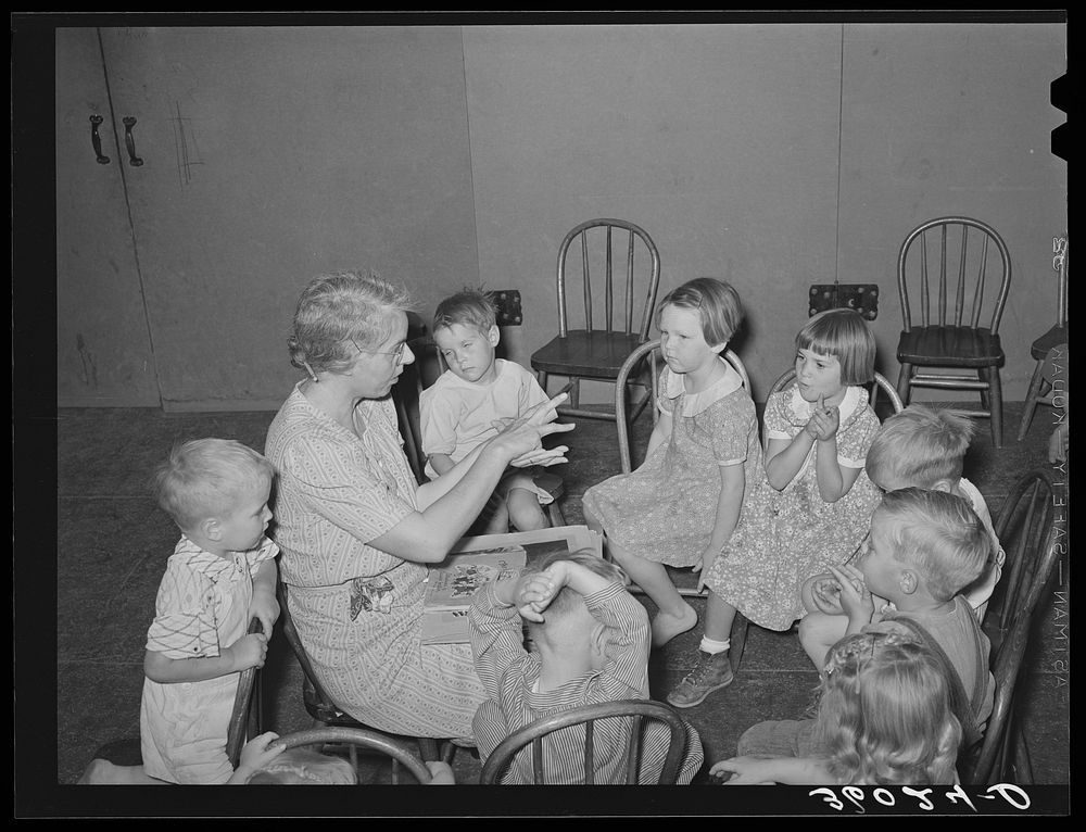 WPA (Work Projects Administration) nursery teacher telling story to children of agricultural workers living at the Agua Fria…
