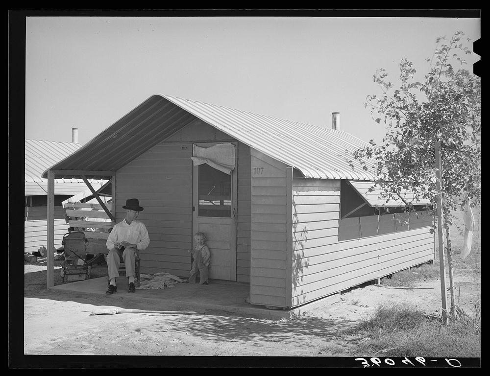 Type of individual family metal shelter at the Agua Fria migratory labor camp. Arizona by Russell Lee