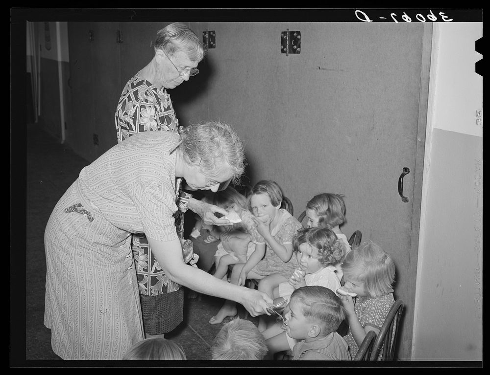 Children receiving cod liver oil and grapefruit at the WPA (Work Projects Administration) nursery school at the Agua Fria…