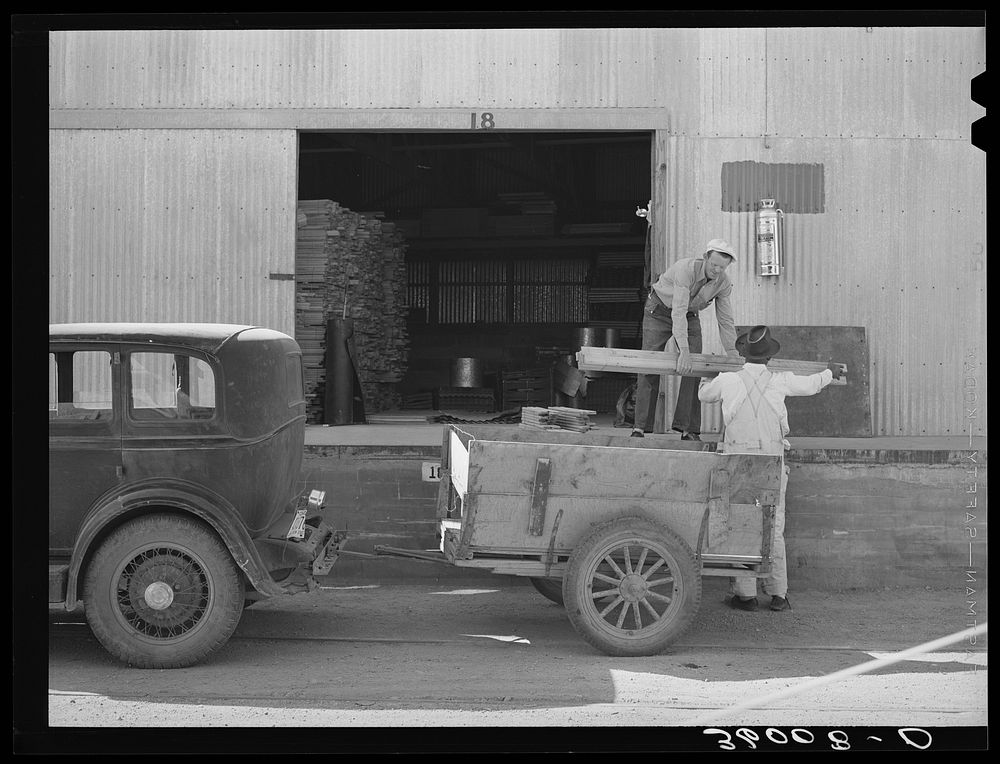 Farmer loading lumber onto his truck at the United Producers and Consumers Cooperative. Phoenix, Arizona by Russell Lee