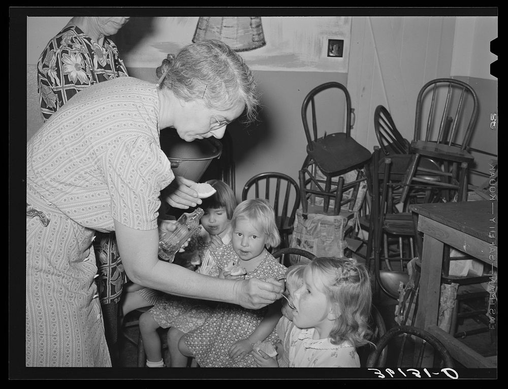 Feeding children of migratory agricultural laborers cod liver oil at the WPA (Work Projects Administration) nursery school…