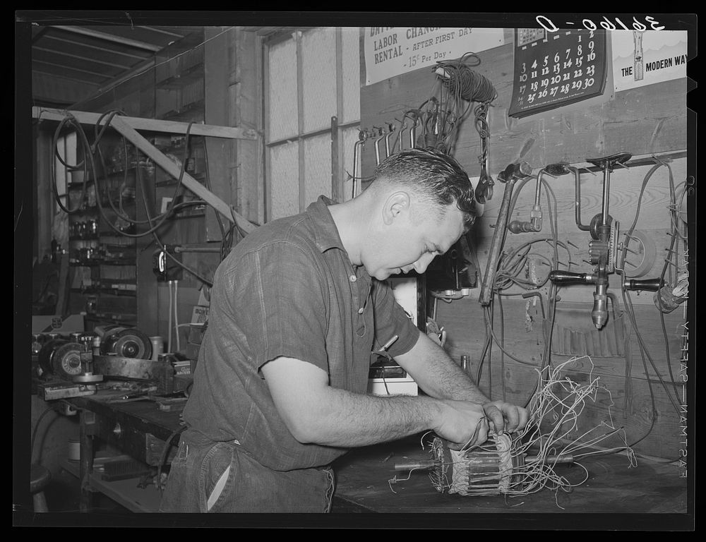 Member of the service department of the United Producers and Consumers Cooperative winding an armature. He was sent by the…