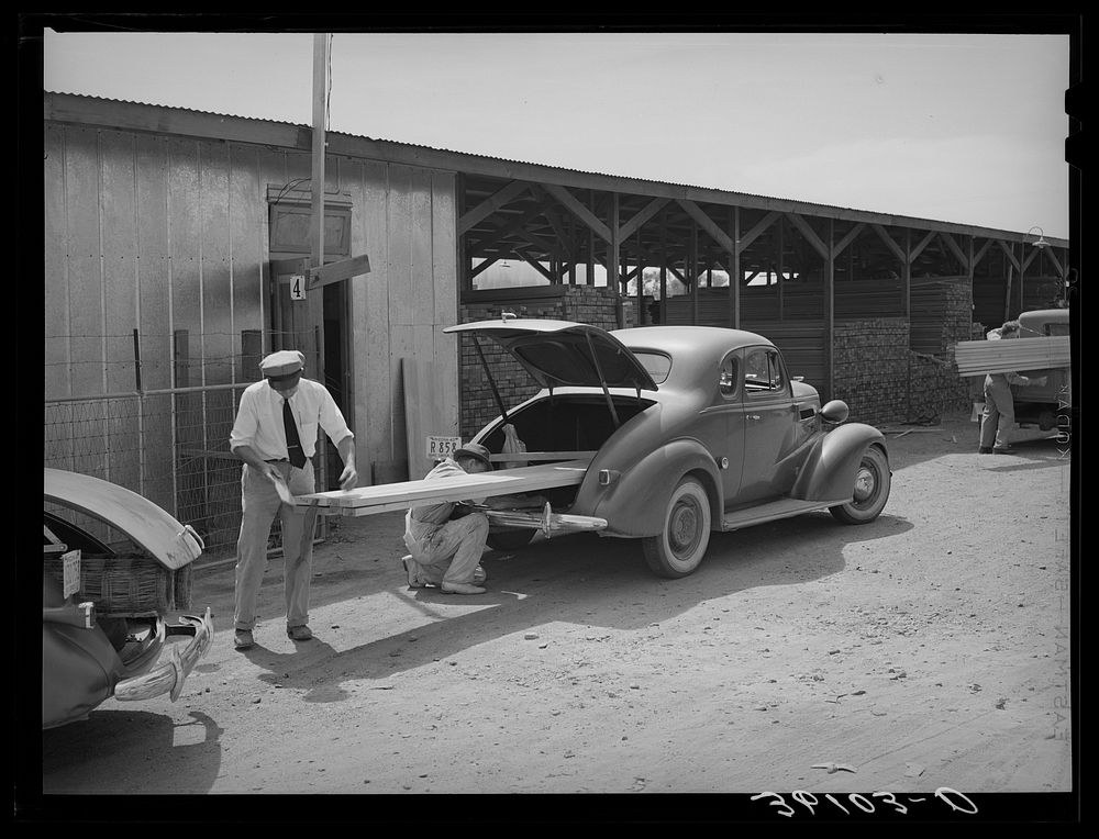 Member of the United Producers and Consumers Cooperative loading lumber into his car. Phoenix, Arizona by Russell Lee