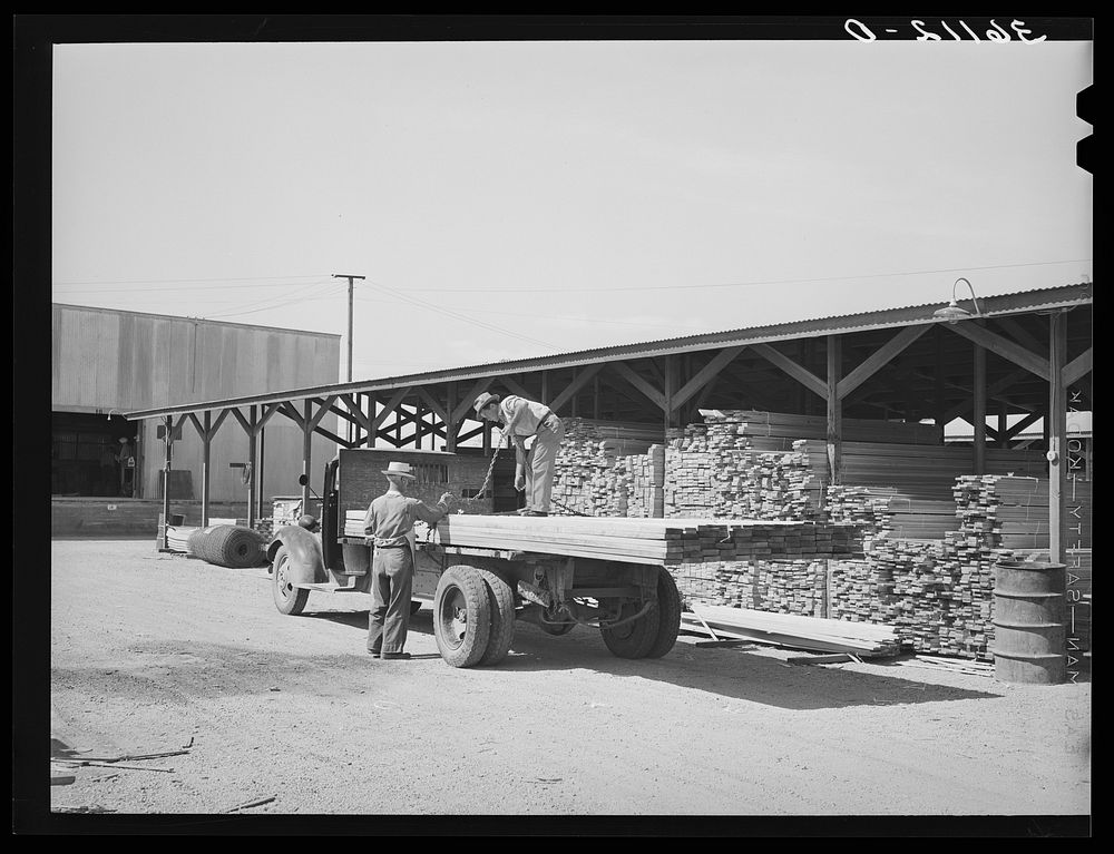 Lumber being loaded onto truck at the Producers and Consumers Cooperative. Phoenix, Arizona by Russell Lee