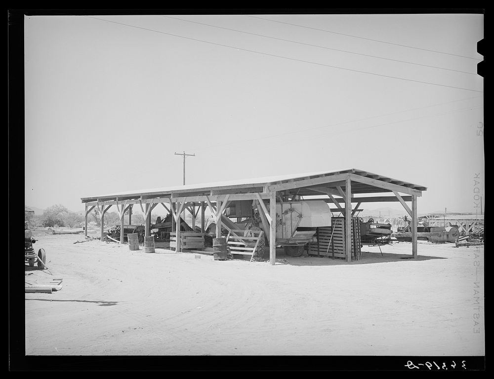 Shelter for farm machinery at the Casa Grande Valley Farms. Pinal County, Arizona by Russell Lee