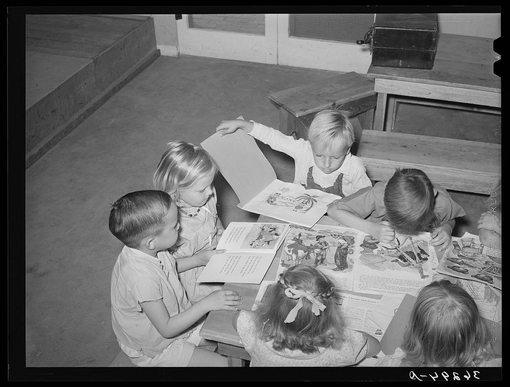 Children looking at picture books at the WPA (Work Projects Administration) nursery school at the Casa Grande Valley Farms.…