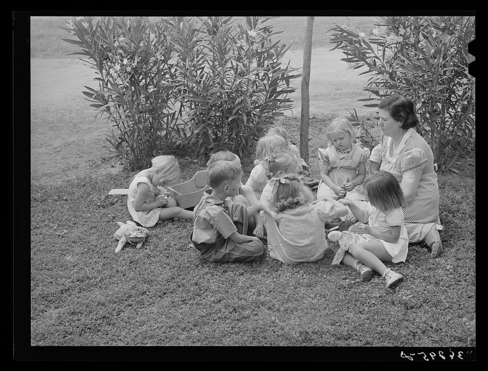WPA (Work Projects Administration) nursery school supervisor with her young charges at the Casa Grande Valley Farms. Pinal…