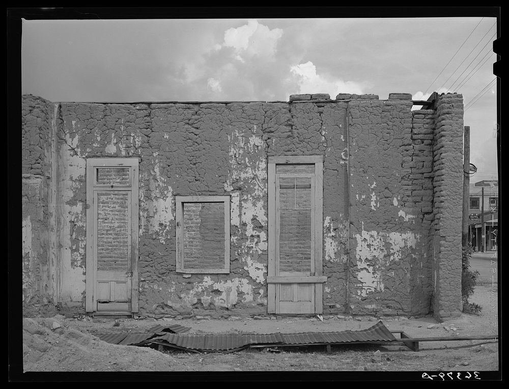Cracking adobe walls in abandoned building in Tombstone, Arizona by Russell Lee