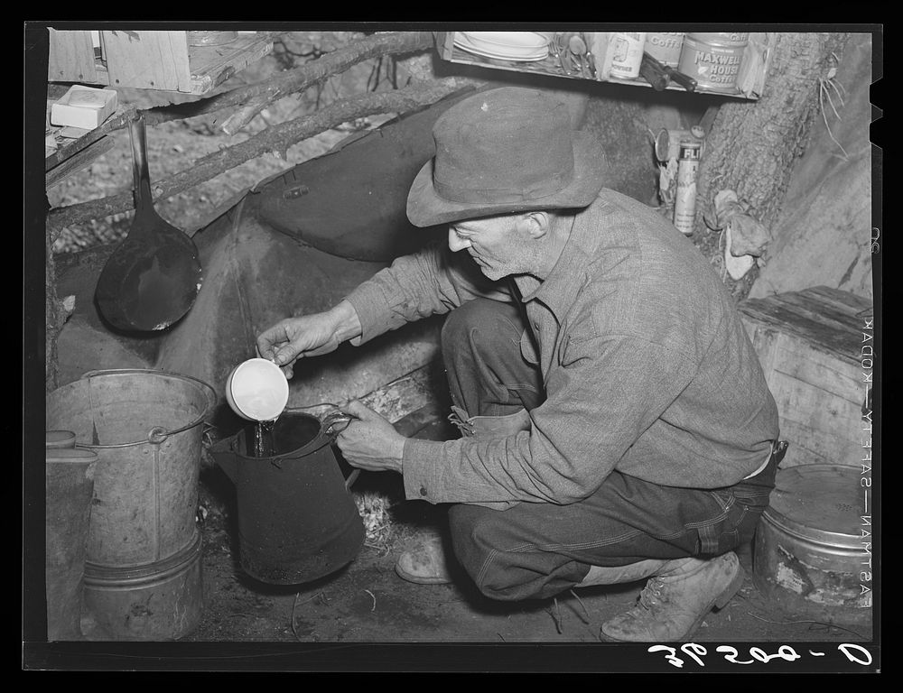 [Untitled photo, possibly related to: Eugene Davis, gold prospector, making a pot of coffee in his shack on his diggings at…