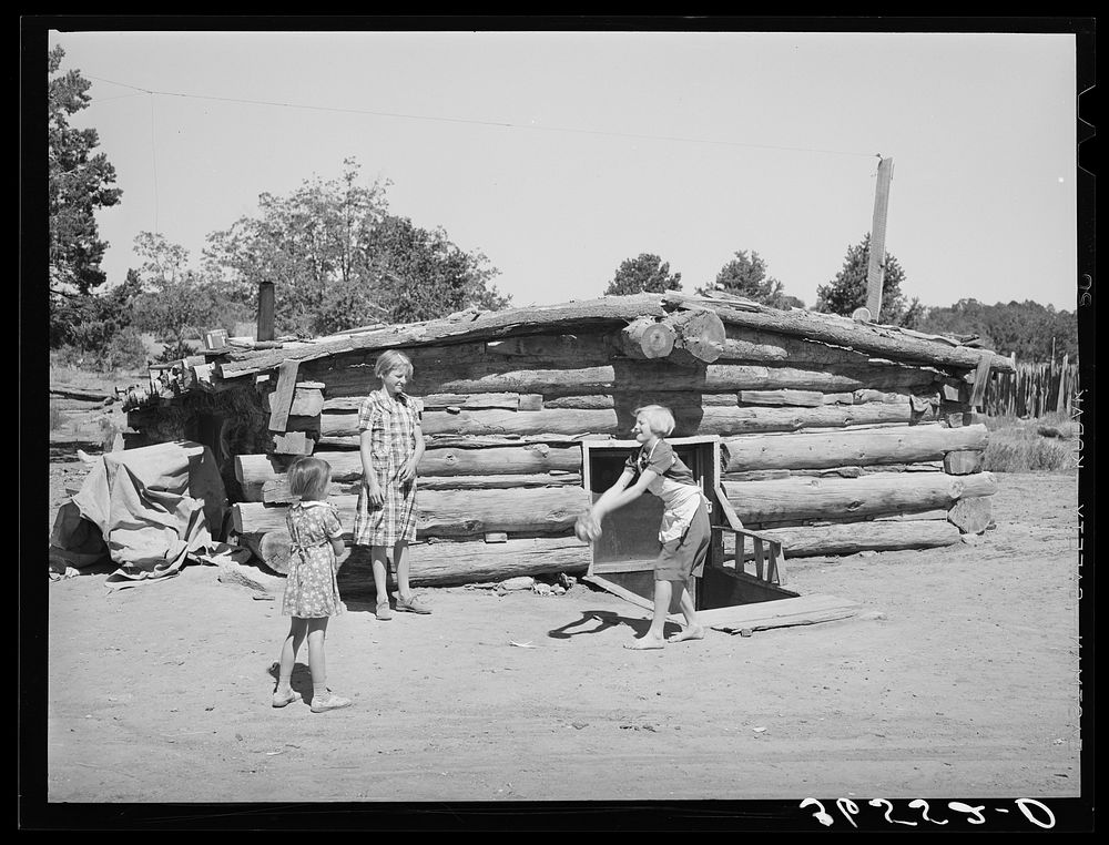 Children playing in front of dugout. Pie Town, New Mexico by Russell Lee