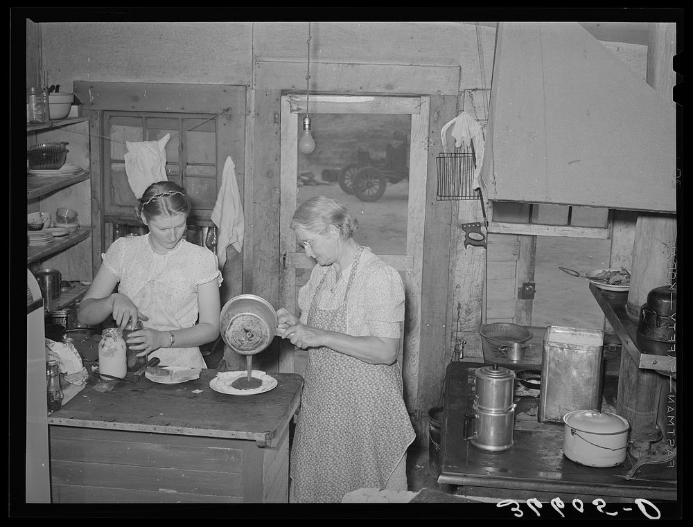 Mother and daughter working in the cafe kitchen. The daughter with her husband run the cafe. Pie Town, New Mexico by Russell…