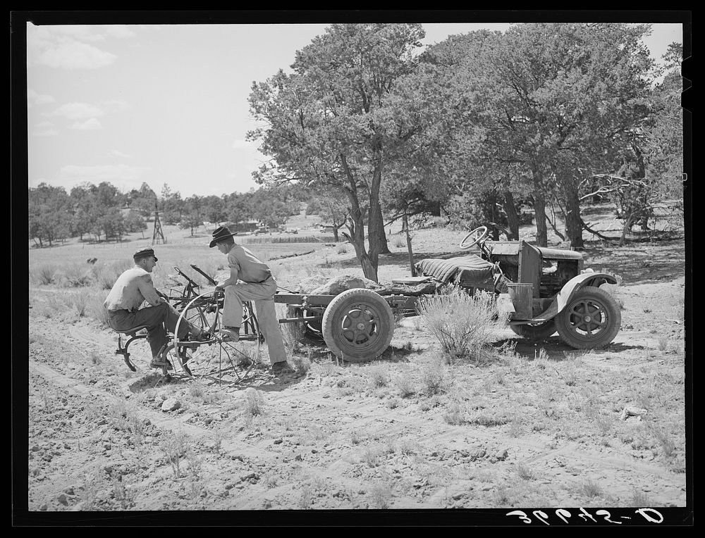 Farmer and his younger brother with tractor which has been adapted from truck. Pie Town, New Mexico by Russell Lee