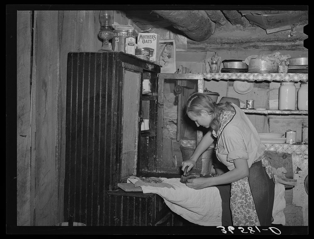 Mrs. Faro Caudill ironing. Pie Town, New Mexico. Mrs. Caudill was born and finished high school at Sweetwater, Texas, before…