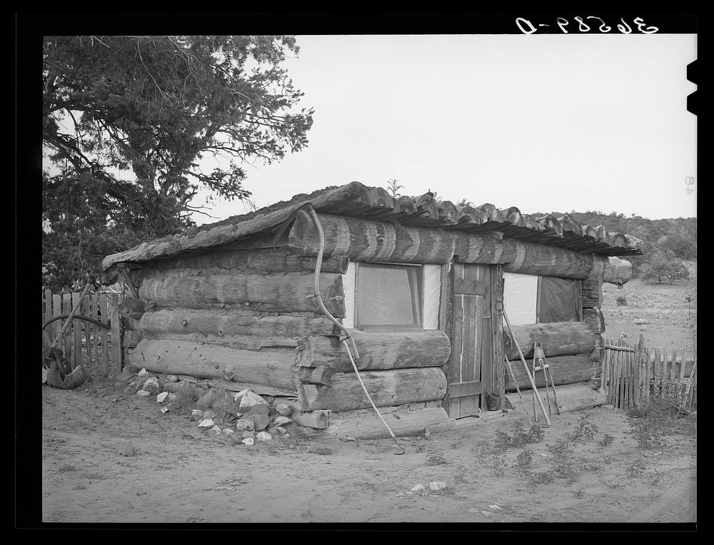 Original log home of homesteader. They have this year built an adobe house. Pie Town, New Mexico by Russell Lee