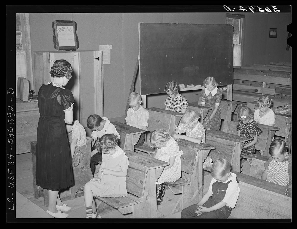 School opens with prayer. This is the private school in the Farm Bureau building. Pie Town, New Mexico by Russell Lee