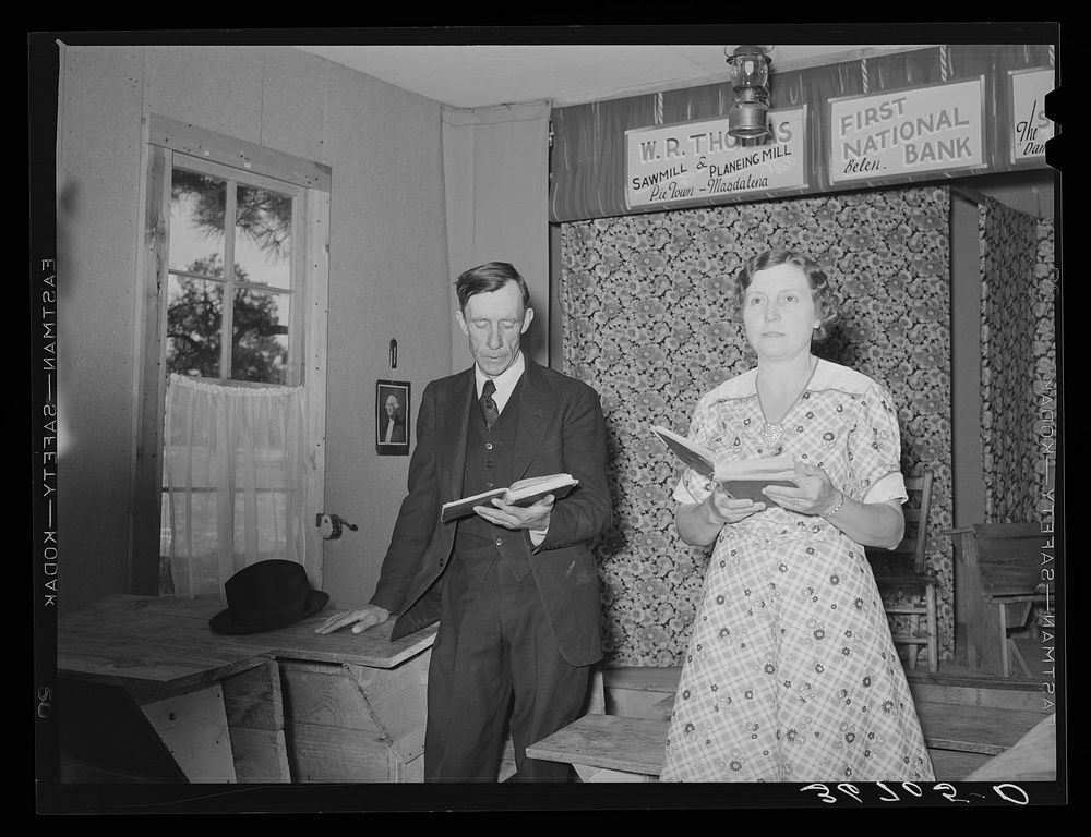 Farmer and his wife leading the singing at Sunday school. Pie Town, New Mexico by Russell Lee