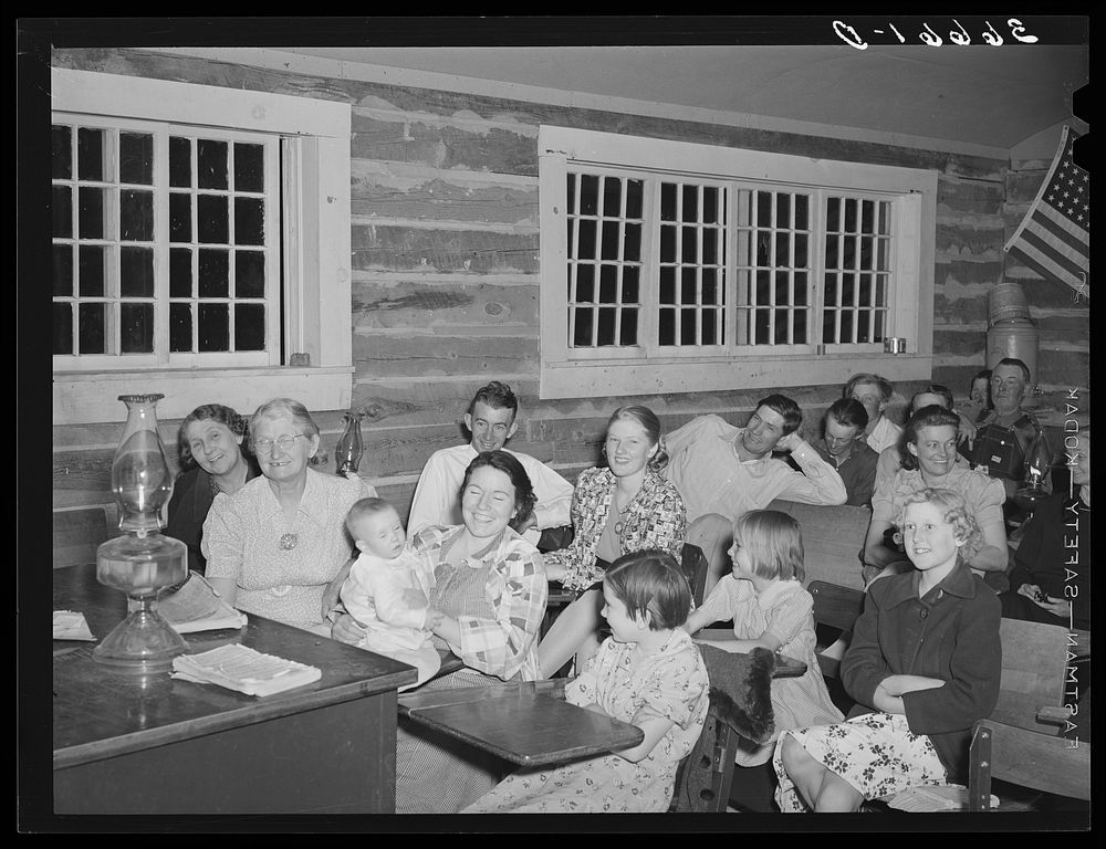 Farmers and their families enjoying the literary society meeting. Pie Town, New Mexico by Russell Lee