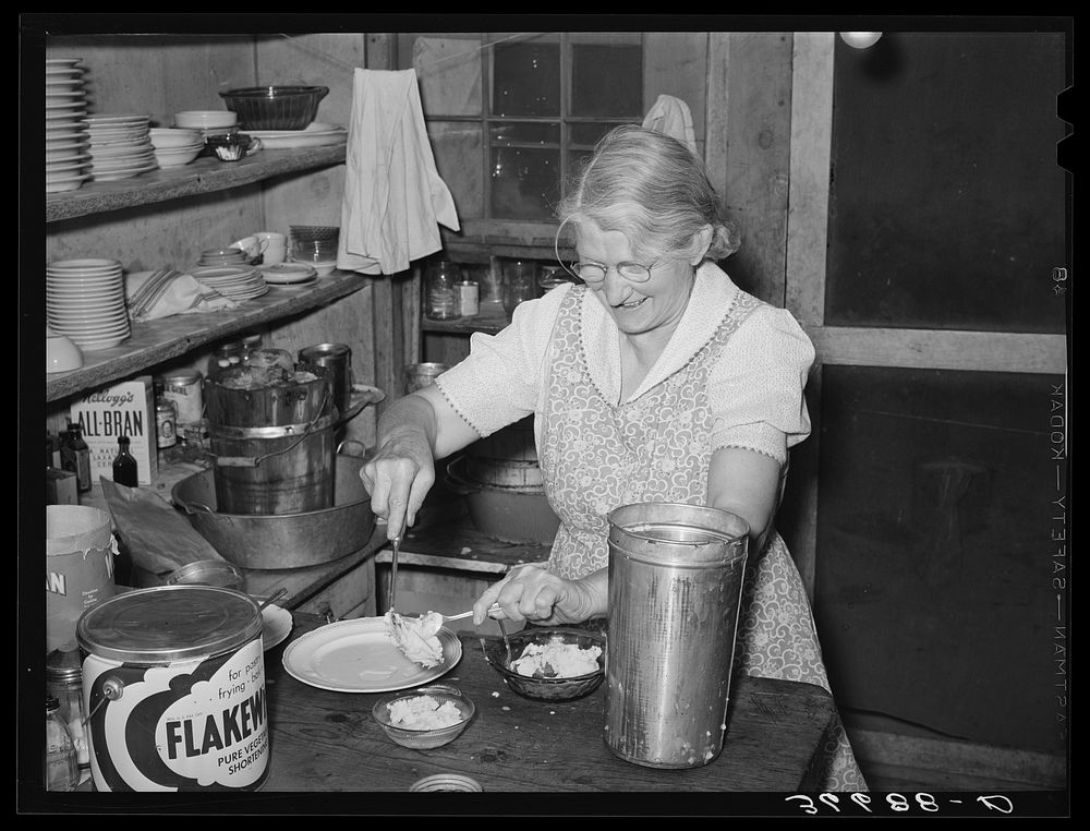 Mrs. Holley, Sr., dishing up ice cream. Pie Town, New Mexico by Russell Lee