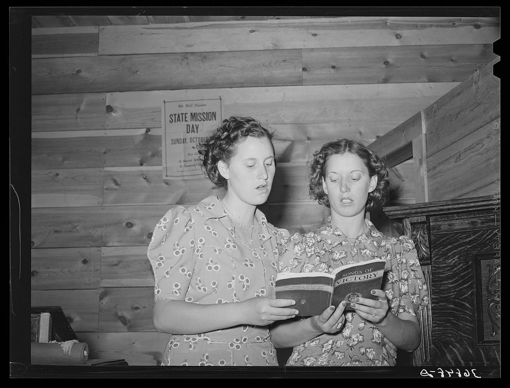 Two sisters singing a duet at the community sing. Pie Town, New Mexico by Russell Lee