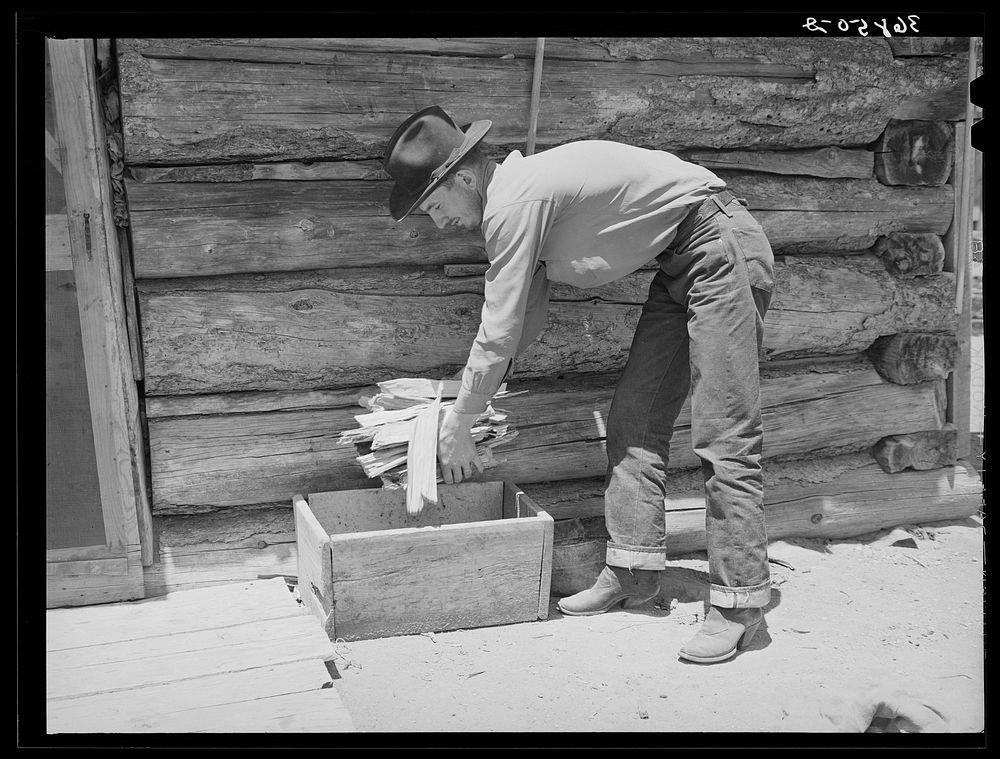 Farmer getting wood for the cook stove. Pie Town, New Mexico by Russell Lee