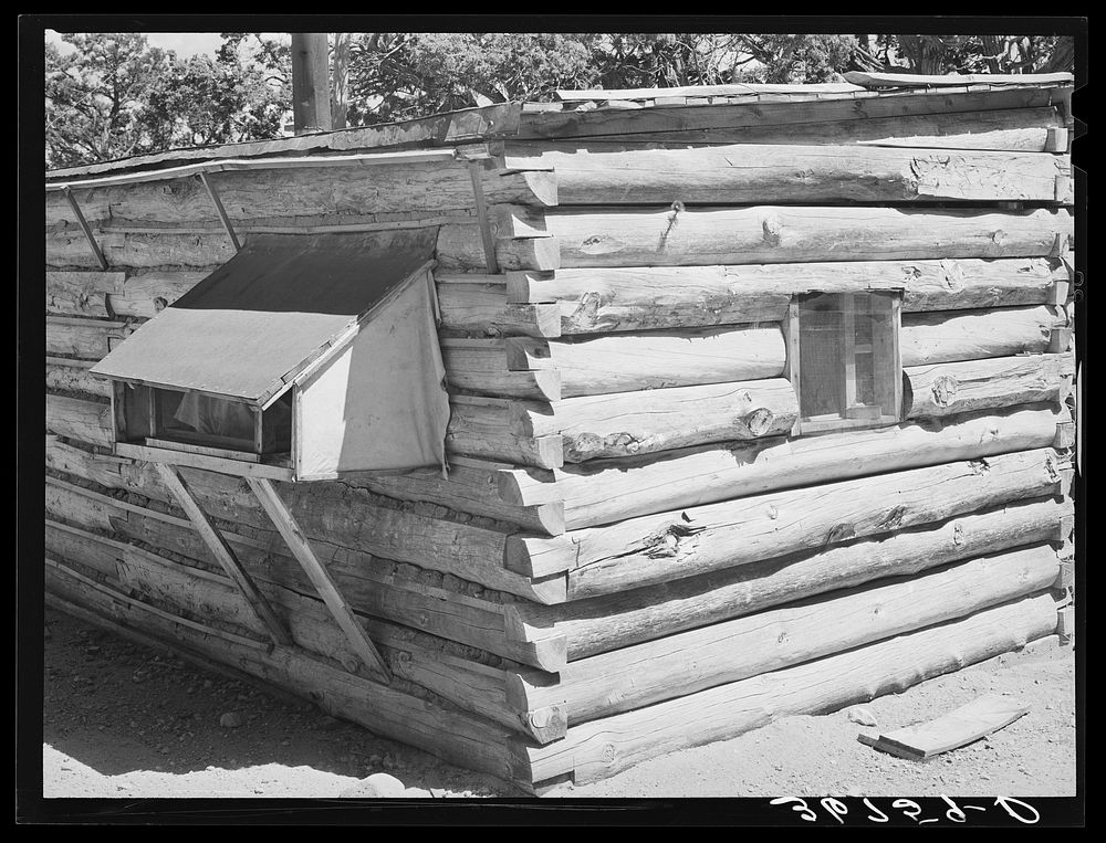 Corner of log house. Canvas-sided box at left is cooler. Milk, water, etc., are wrapped in wet cloths and the canvassed box…
