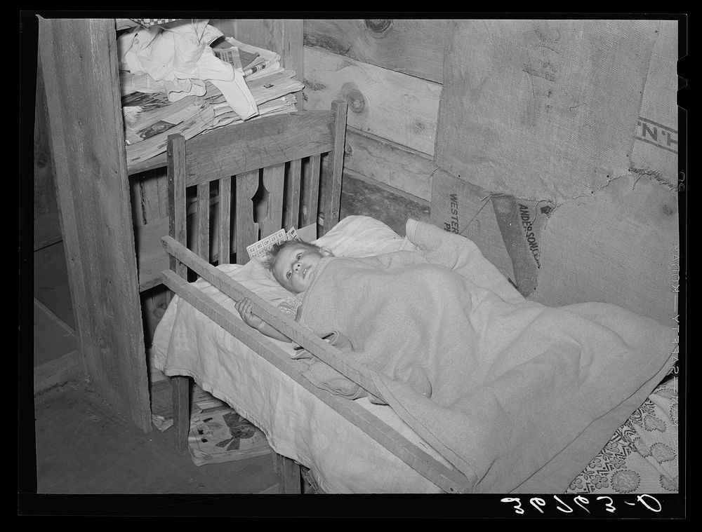 The Whinery baby in his homemade bed. Pie Town, New Mexico by Russell Lee