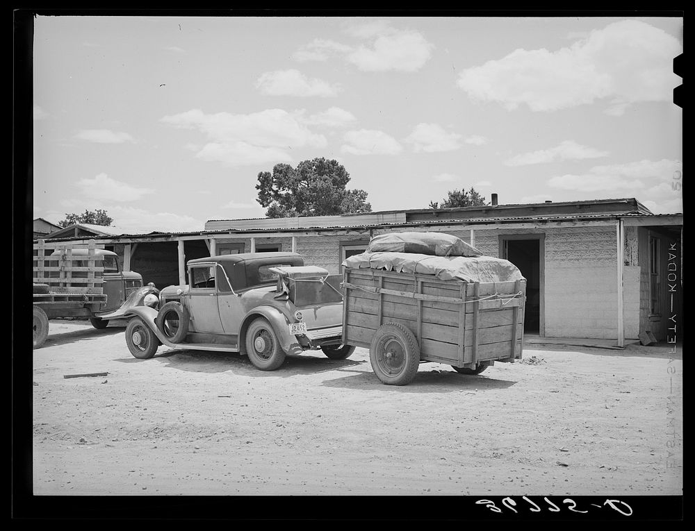 Car and trailer belonging to family coming through Pie Town, New Mexico, in search of work in the tie-cutting camp by…