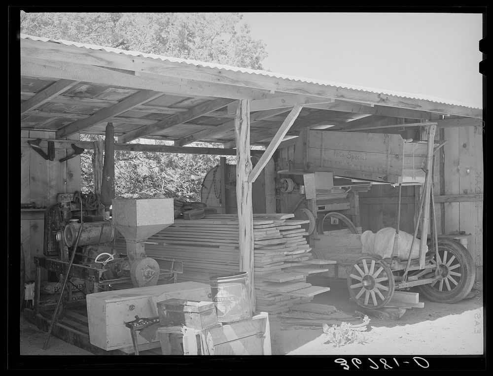 Toolshed on farm of George Hutton. Notice the homemade bean thresher at the right. Pie Town, New Mexico by Russell Lee