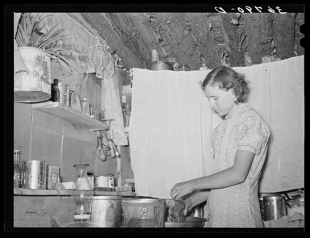 Mrs. Jack Whinery working in kitchen of her dugout. Pie Town, New Mexico by Russell Lee