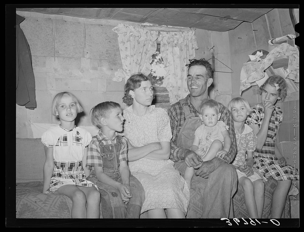 Mr. and Mrs. Jack Whinery and their five children in their dugout. Pie Town, New Mexico. Mr. Whinery had worked on farms in…