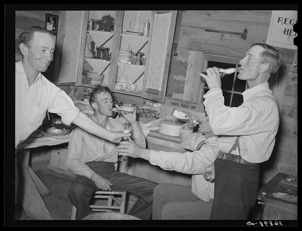 The men have a bottle of beer at the square dance. Pie Town, New Mexico by Russell Lee