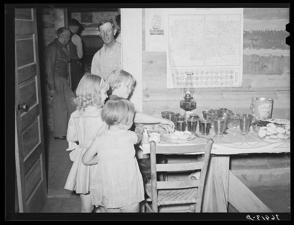 Children getting refreshments at the square dance. Pie Town, New Mexico by Russell Lee