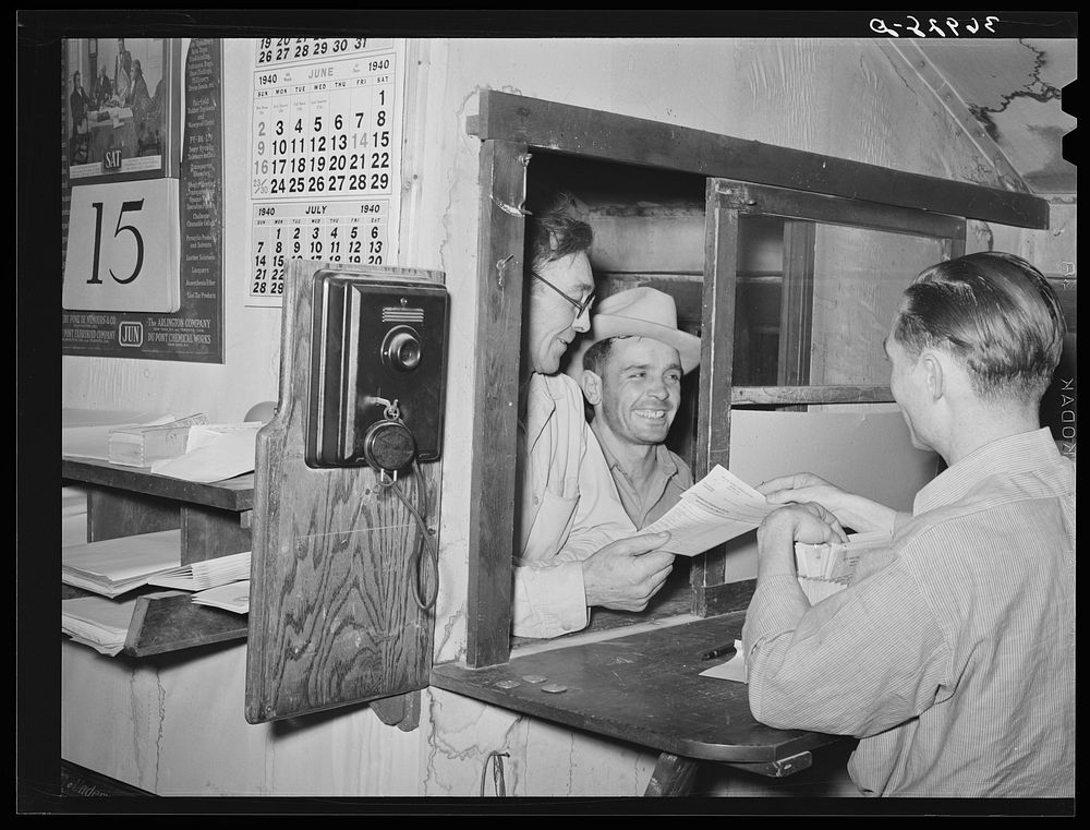 Workers at mine receiving paychecks. Mogollon, New Mexico by Russell Lee