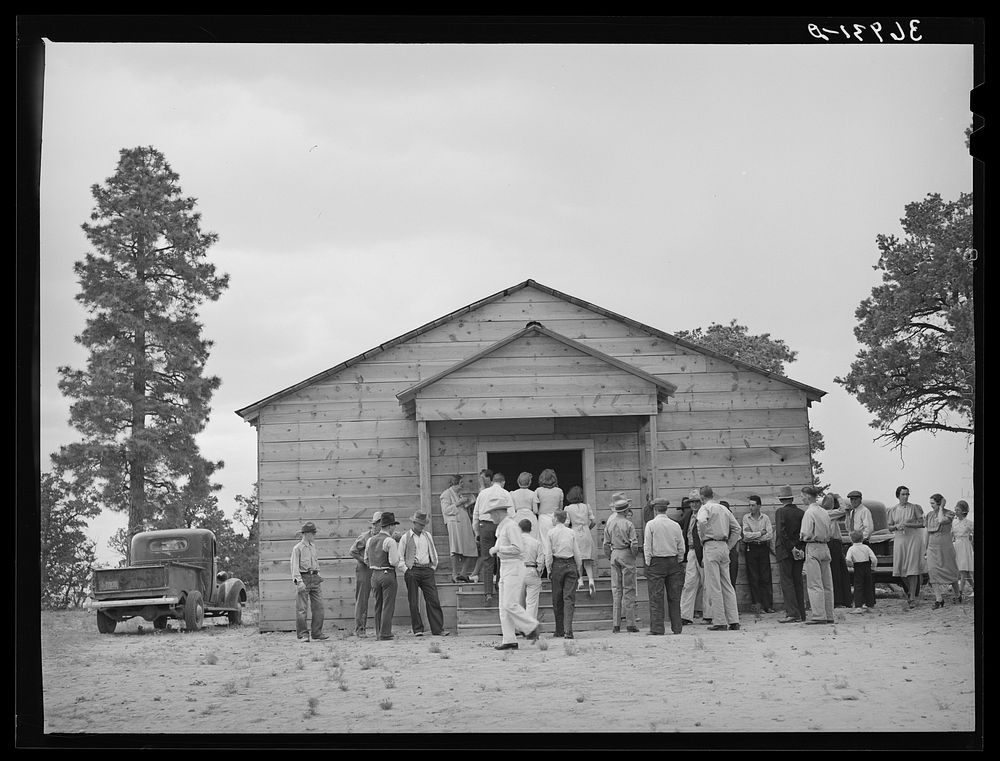 Crowd outside the church during the dinner hour at the community sing. Pie Town, New Mexico by Russell Lee
