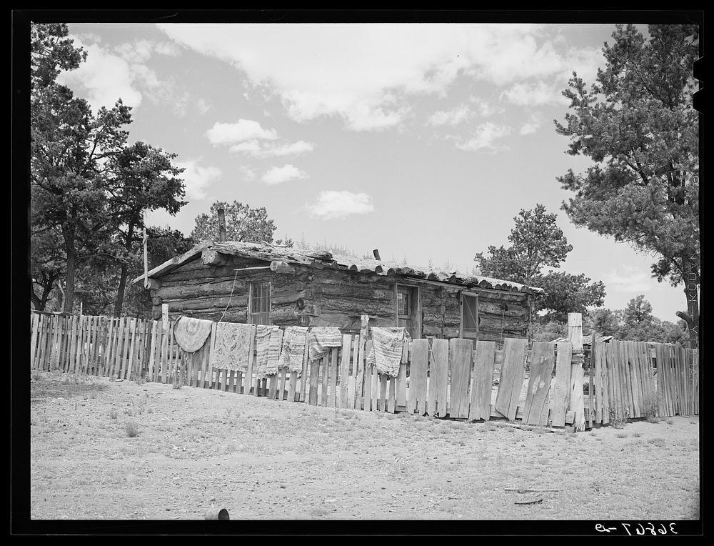 Log house of farmer with a fence of hand-split rails. Pie Town, New Mexico by Russell Lee