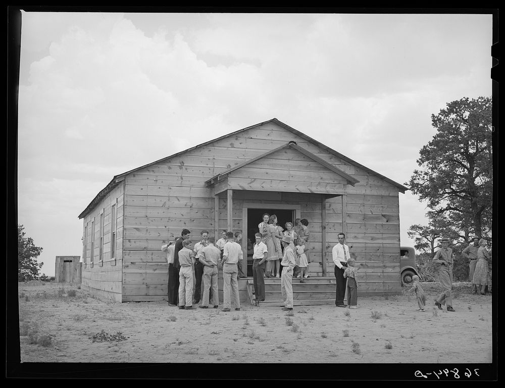 Farm folks in front of church before community sing starts. Pie Town, New Mexico by Russell Lee