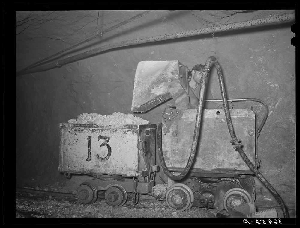 Automatic mucking machine at gold mine. Mogollon, New Mexico. Scoop picks up the ore and deposits it in the car for…