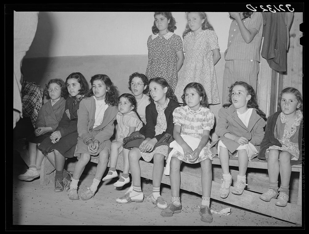 Spanish-American children watching show. Penasco, New Mexico by Russell Lee