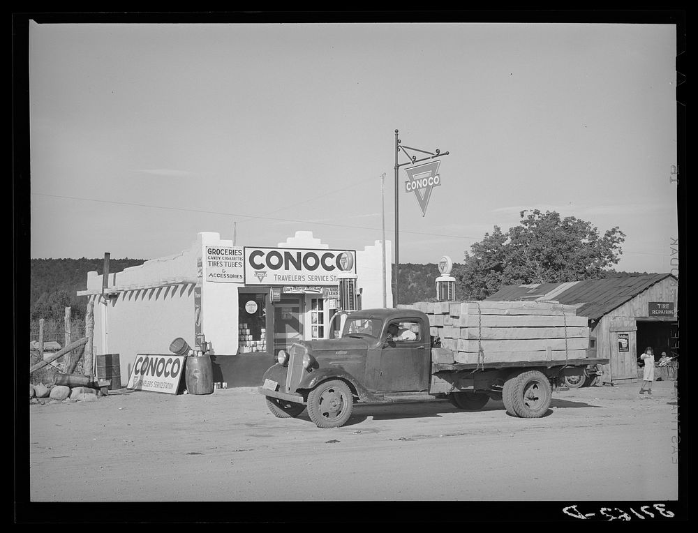 Truck and filling station, Penasco, New Mexico. All supplies come into the town by truck by Russell Lee