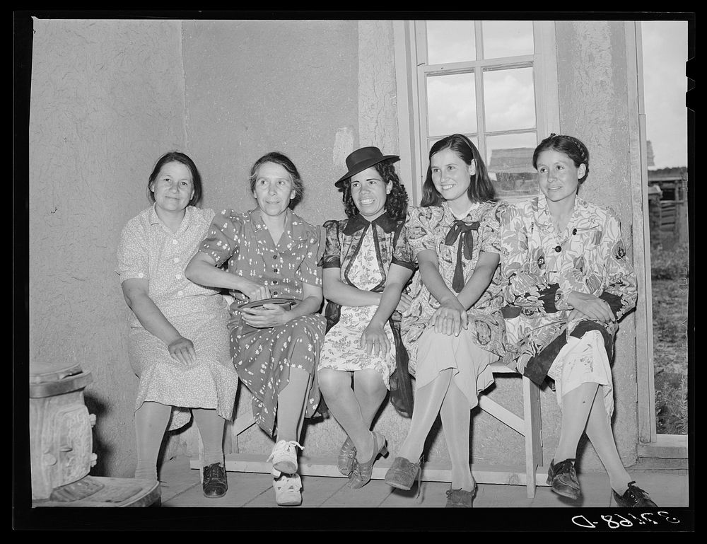 Spanish-American women waiting to see doctor at the traveling clinic at Chamisal, New Mexico by Russell Lee