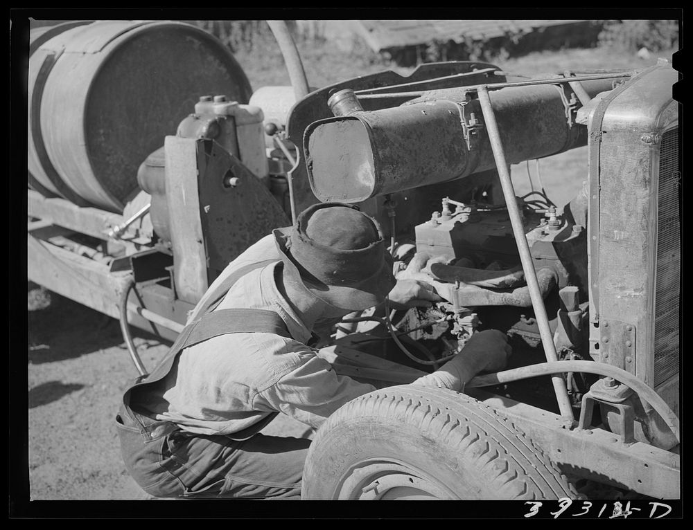 [Untitled photo, possibly related to: Pouring gasoline into tank of converted automobile which supplies power for FSA (Farm…