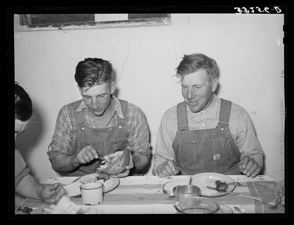 Mormon farmers at dinner table. Box Elder County, Utah by Russell Lee