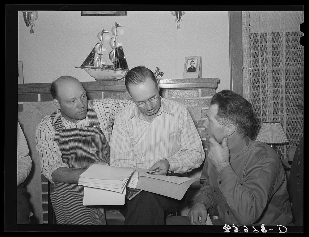 FSA (Farm Security Administration) county supervisor, center, offering technical information concerning the running the…
