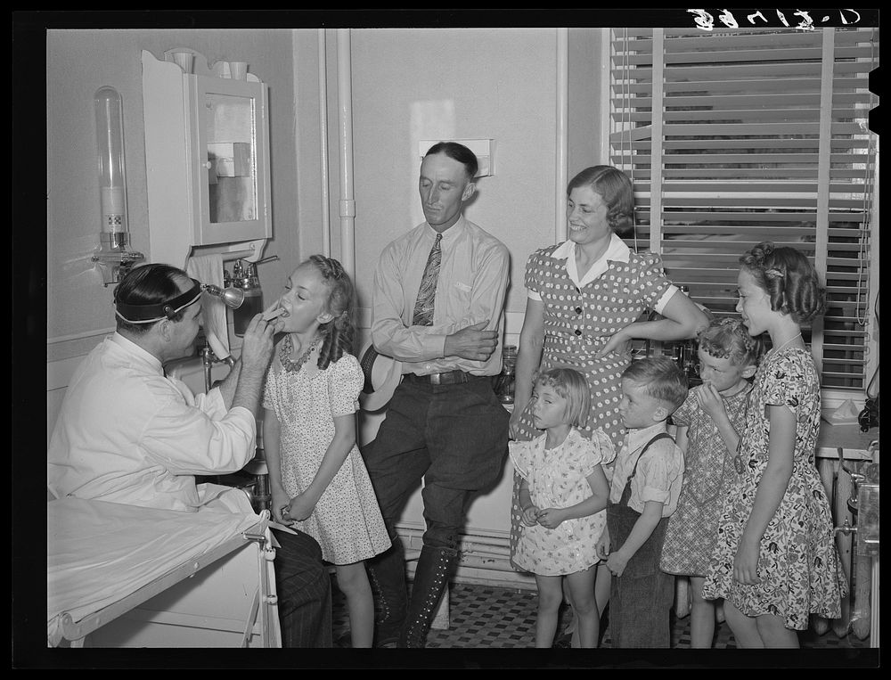[Untitled photo, possibly related to: Doctor with family who are members of the FSA (Farm Security Administration) medical…