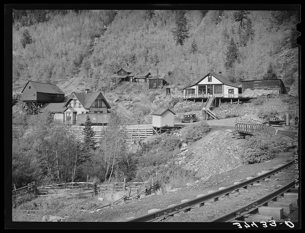 Railroad station and liquor store at Ophir, Colorado. A narrow gauge railway runs into the town with supplies and takes out…