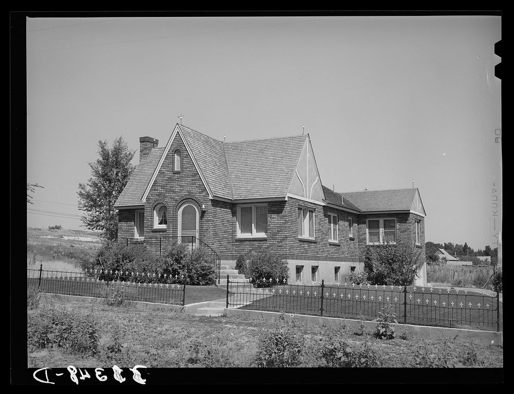 [Untitled photo, possibly related to: Houses belonging to a Mormon farmer in Mendon, Utah. The new house was built with…