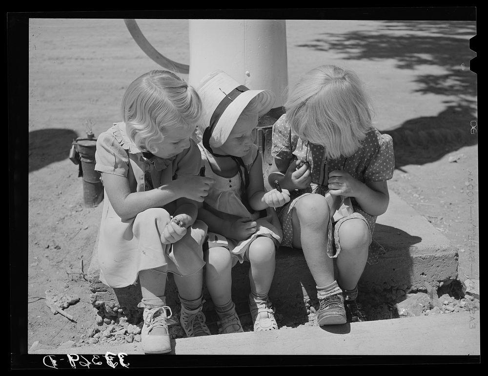 Three little Mormon girls with candy. Mendon, Utah by Russell Lee