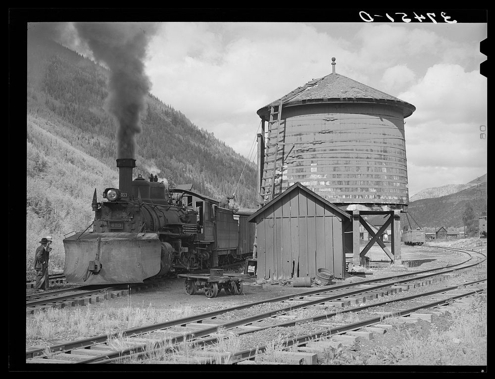 [Untitled photo, possibly related to: Narrow gauge railway yards, train and water tank at Telluride, Colorado] by Russell Lee