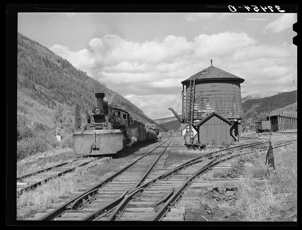 Narrow gauge railway yards, train and water tank at Telluride, Colorado by Russell Lee