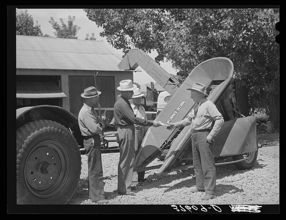 Chairman of Cornish machinery cooperative handing over check to dealer in payment of ensilage harvester. Preston, Idaho by…